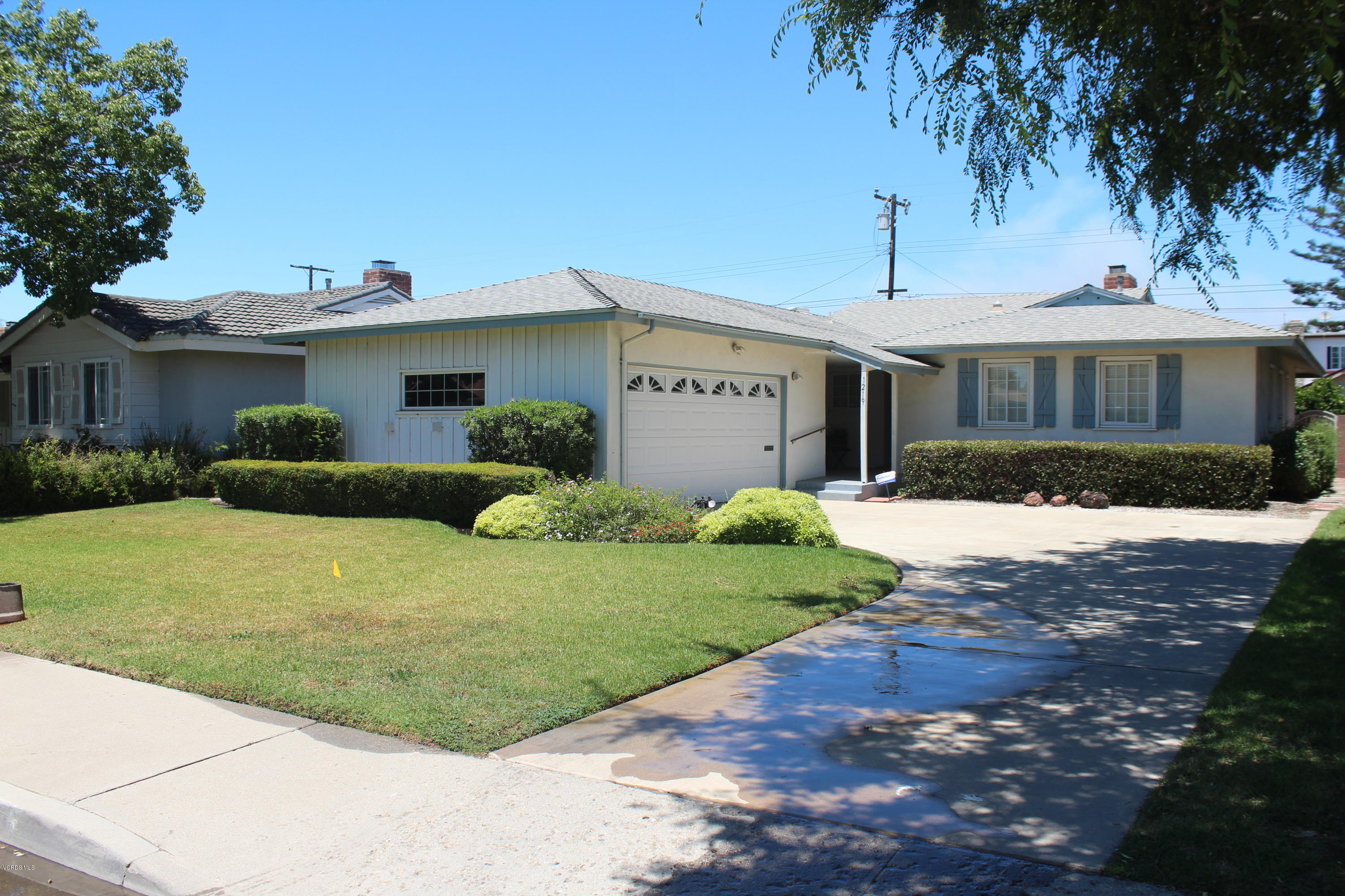 1219 West Roderick Avenue Oxnard, CA 93030 - Photo 1 of 15 a front view of a house with a garden