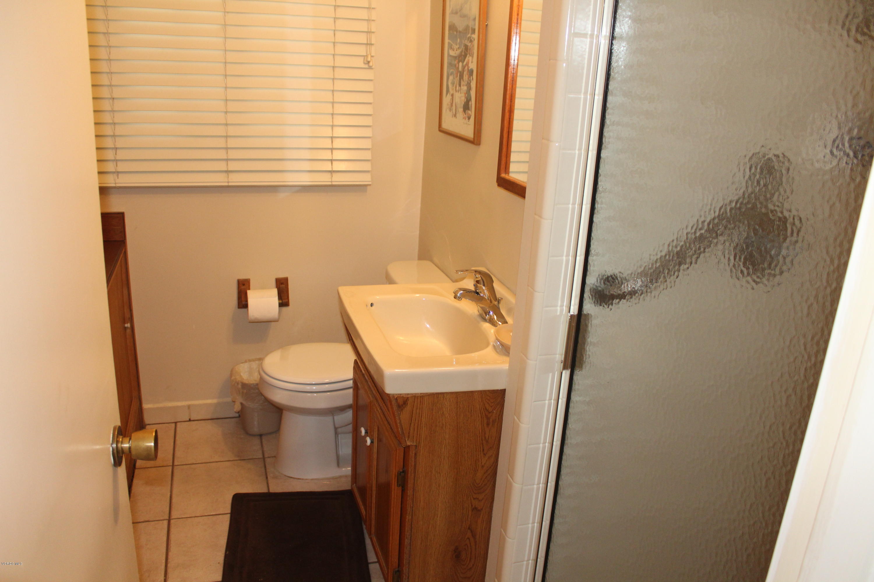 1219 West Roderick Avenue Oxnard, CA 93030 - Photo 12 of 15 a bathroom with a sink and a mirror