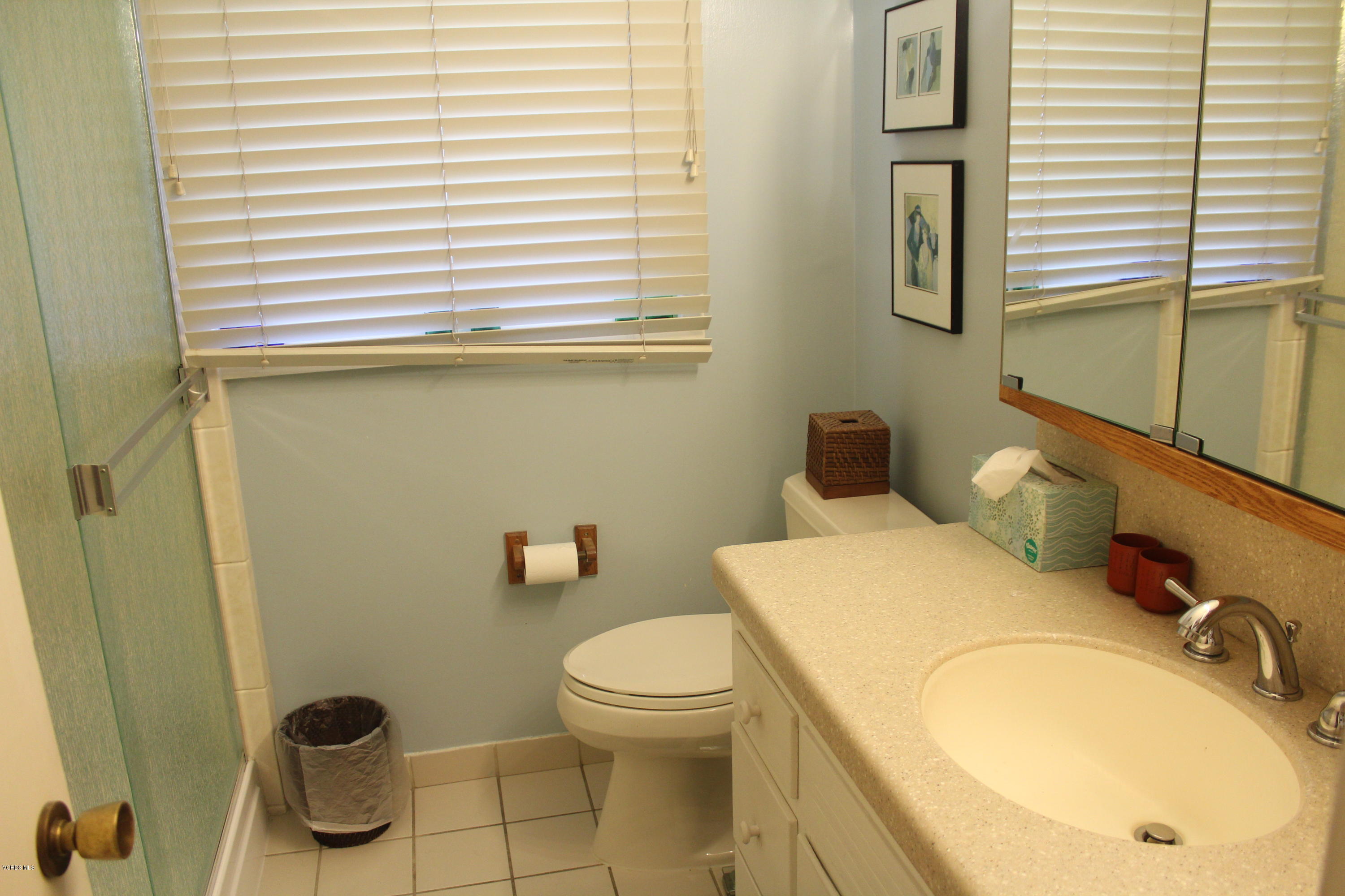 1219 West Roderick Avenue Oxnard, CA 93030 - Photo 13 of 15 a bathroom with a granite countertop toilet and a sink