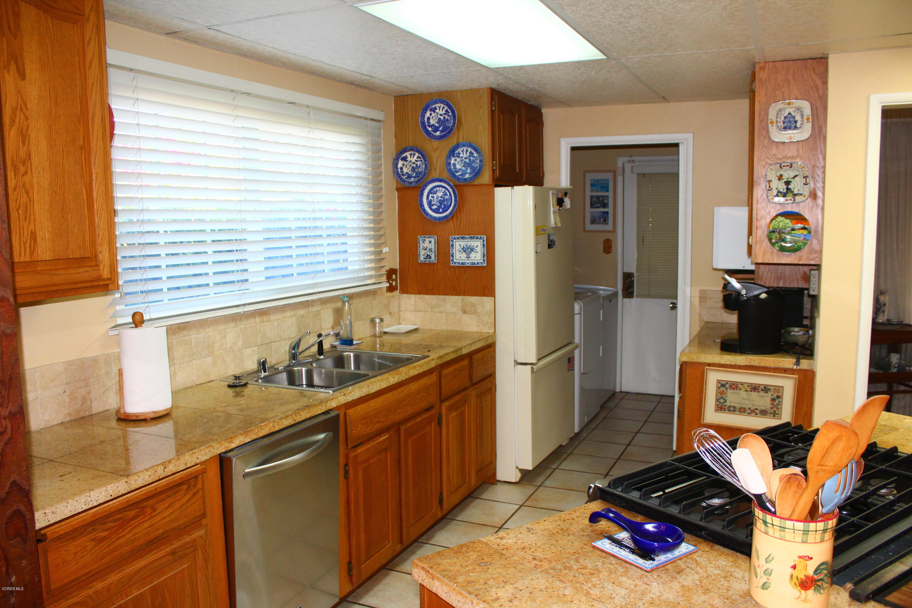 1219 West Roderick Avenue Oxnard, CA 93030 - Photo 3 of 15 a kitchen with stainless steel appliances granite countertop a stove and a sink