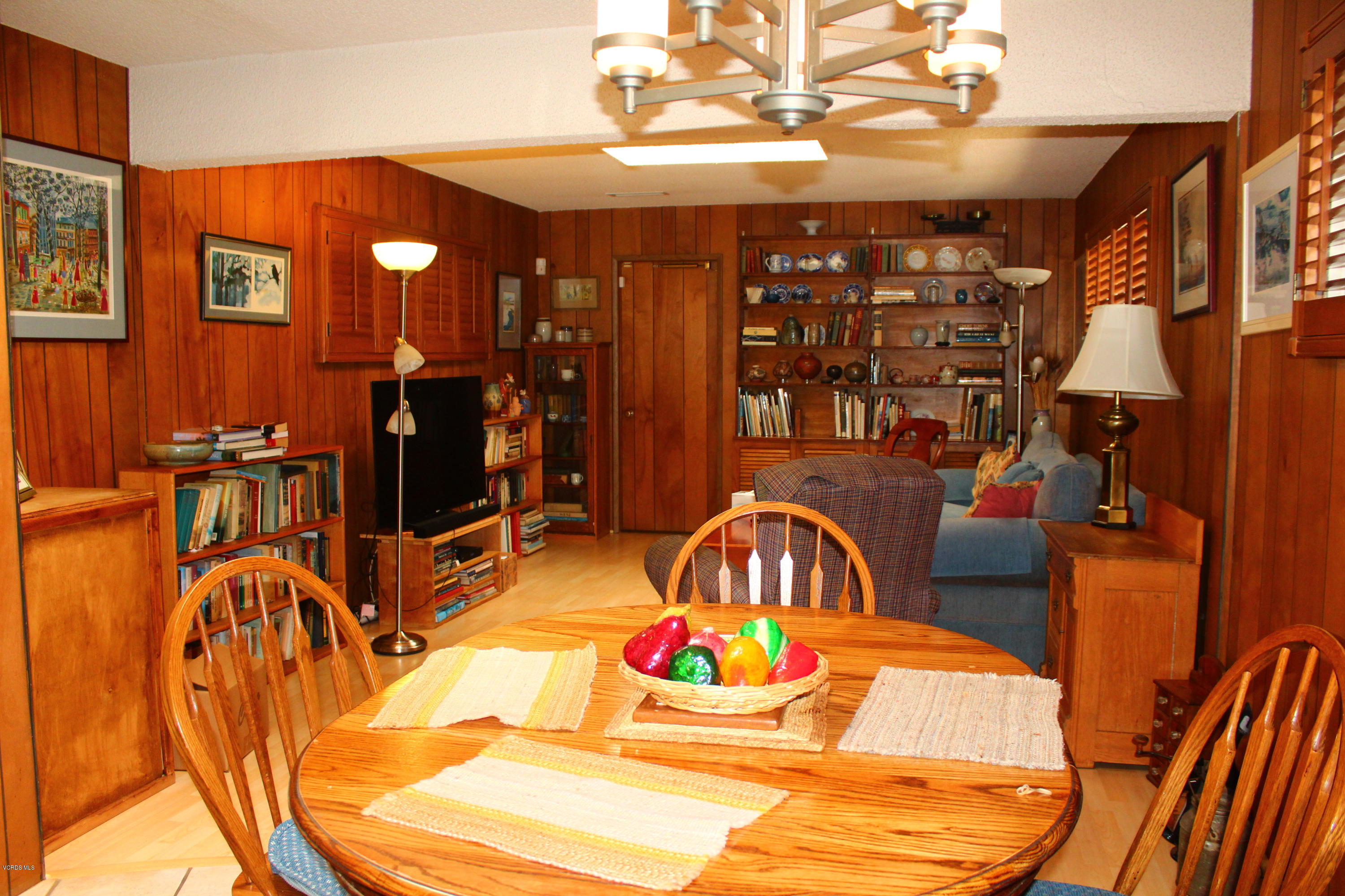 1219 West Roderick Avenue Oxnard, CA 93030 - Photo 4 of 15 a dining room with furniture a chandelier and wooden floor
