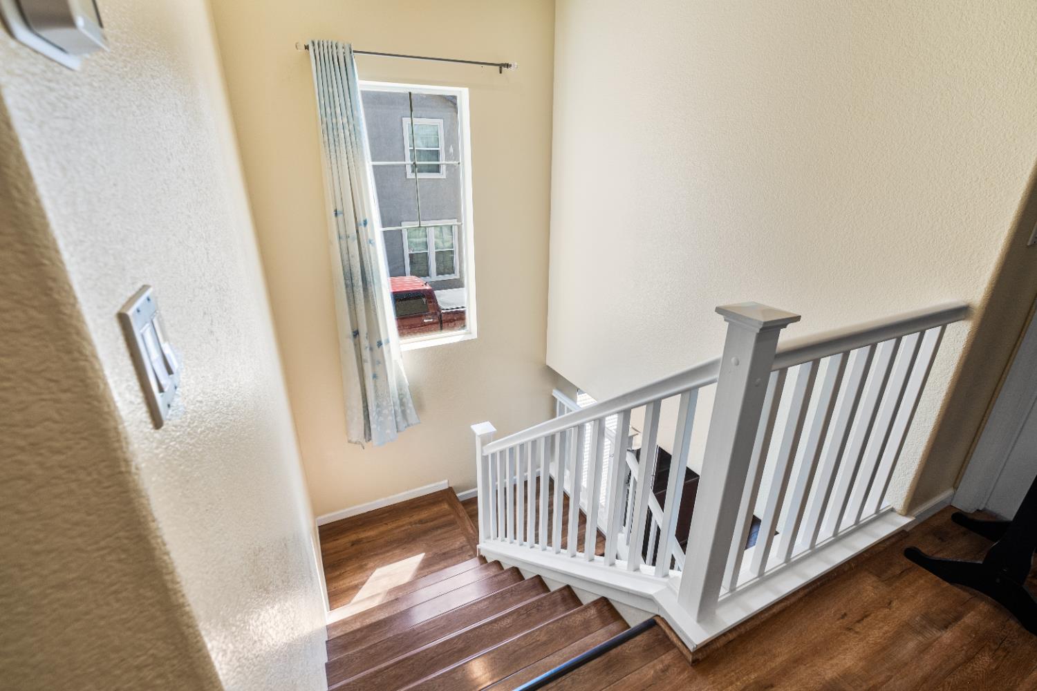 692 Humbert Street Folsom, CA 95630 - Photo 12 of 28 a view of a hallway with wooden floor and staircase