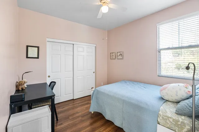 a bedroom with a bed and a potted plant