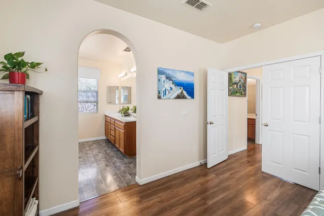 a view of a kitchen with furniture and wooden floor