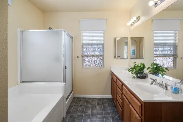 a bathroom with a tub sink and mirror