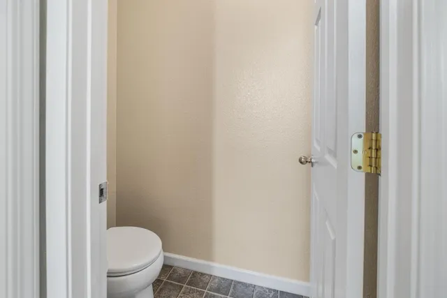 a white toilet sitting next to a shower
