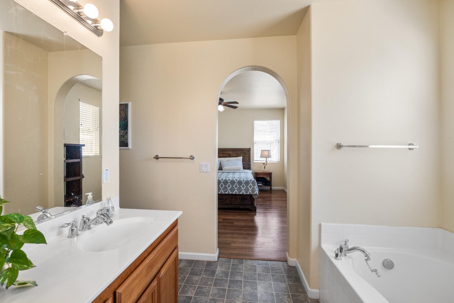 692 Humbert Street Folsom, CA 95630 - Photo 22 of 28 a en suite bathroom with a granite countertop tub sink and mirror