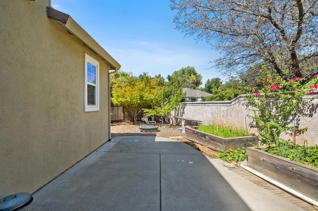 a view of a porch with furniture and a yard
