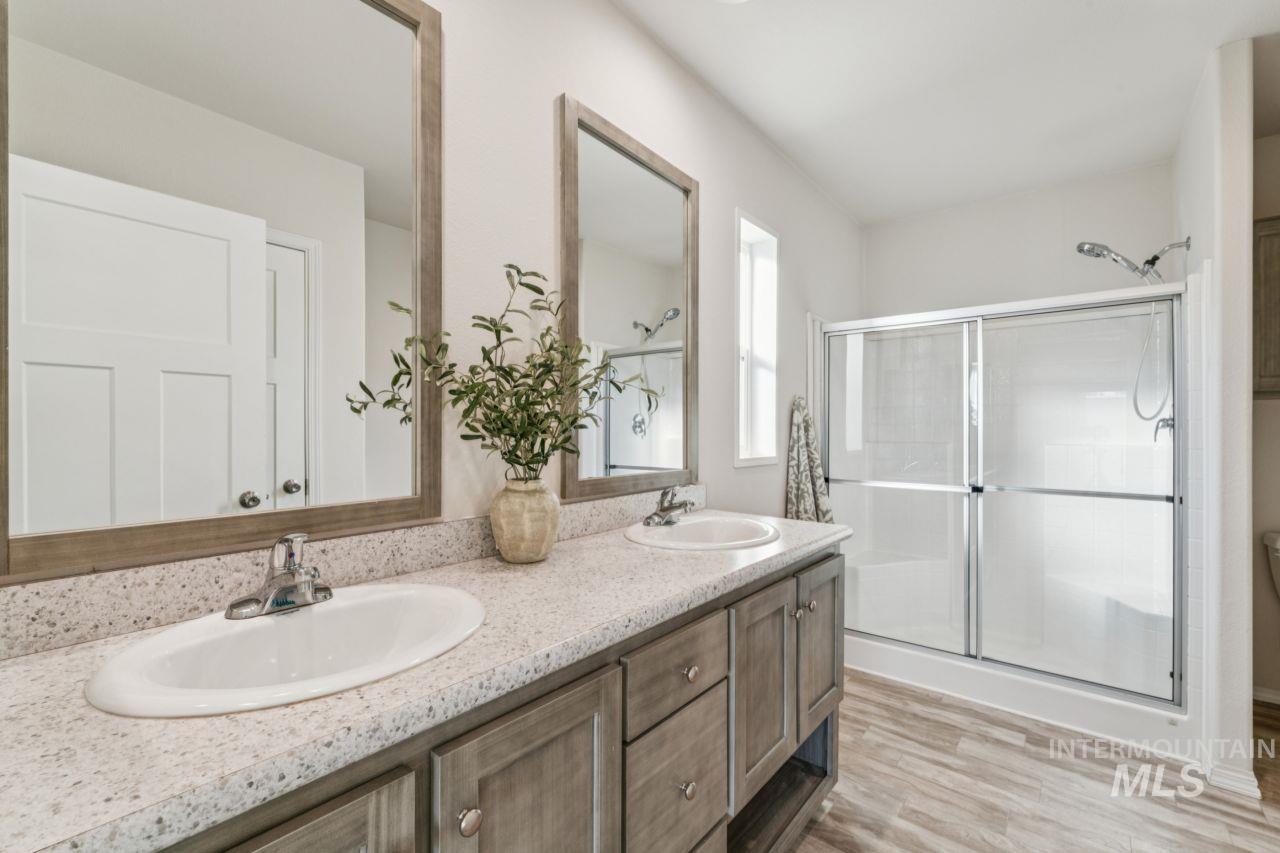 2750 Alden Road, Unit 2 Fruitland, ID 83619 - Photo 10 of 24 Bathroom with a stall shower, light wood-style floors, and double vanity