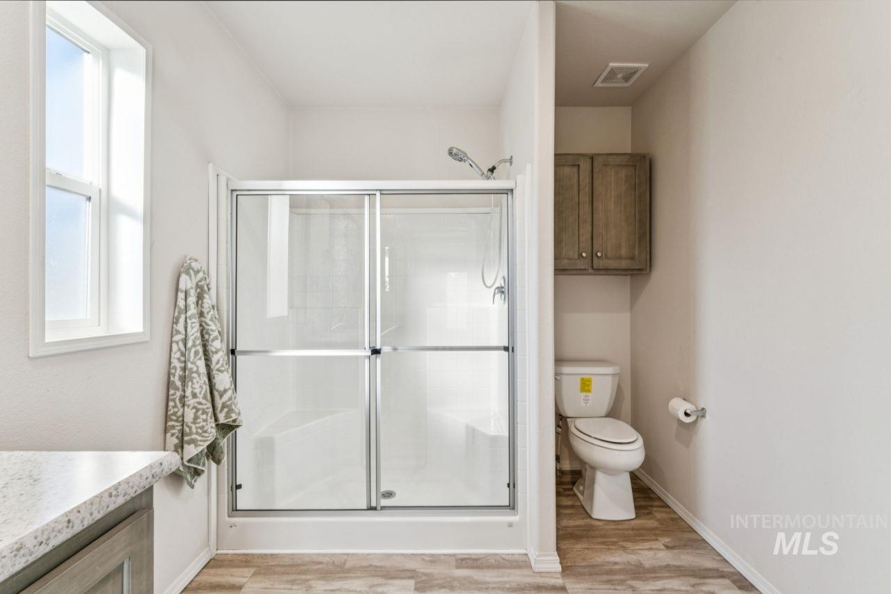 2750 Alden Road, Unit 2 Fruitland, ID 83619 - Photo 11 of 24 Full bath with a stall shower, vanity, and light wood-style floors