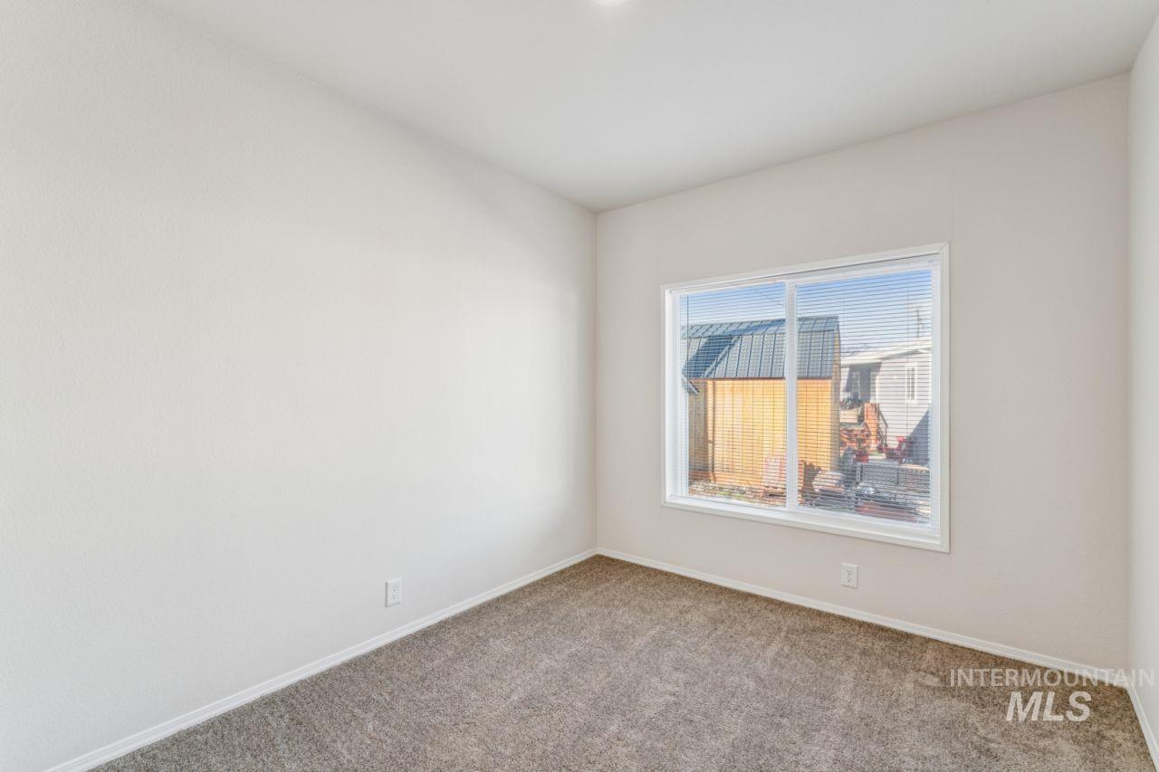 2750 Alden Road, Unit 2 Fruitland, ID 83619 - Photo 13 of 24 Empty room featuring baseboards and carpet flooring