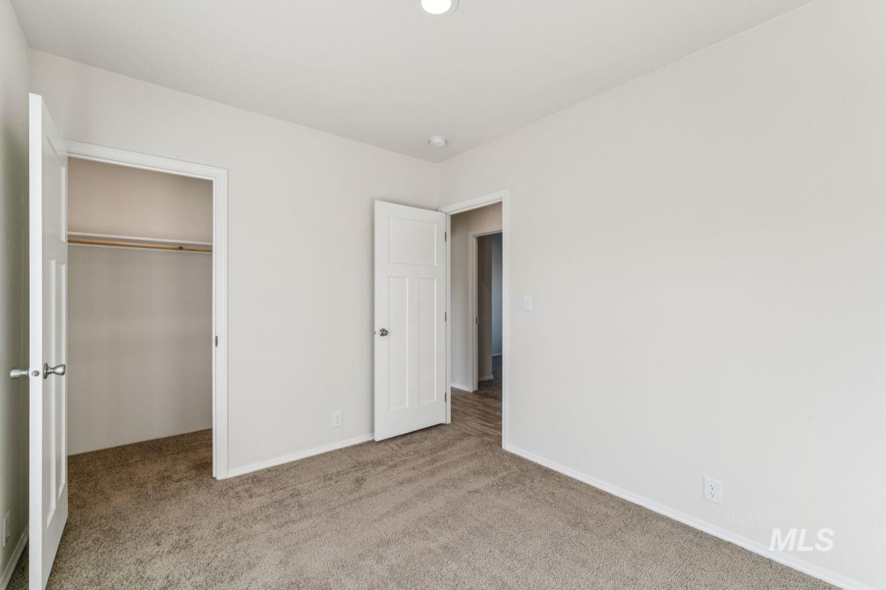 2750 Alden Road, Unit 2 Fruitland, ID 83619 - Photo 15 of 24 Unfurnished bedroom featuring carpet and a walk in closet