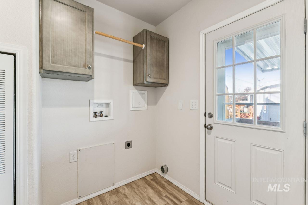 2750 Alden Road, Unit 2 Fruitland, ID 83619 - Photo 18 of 24 Laundry room with washer hookup, cabinet space, electric dryer hookup, light wood-style flooring, and a heating unit