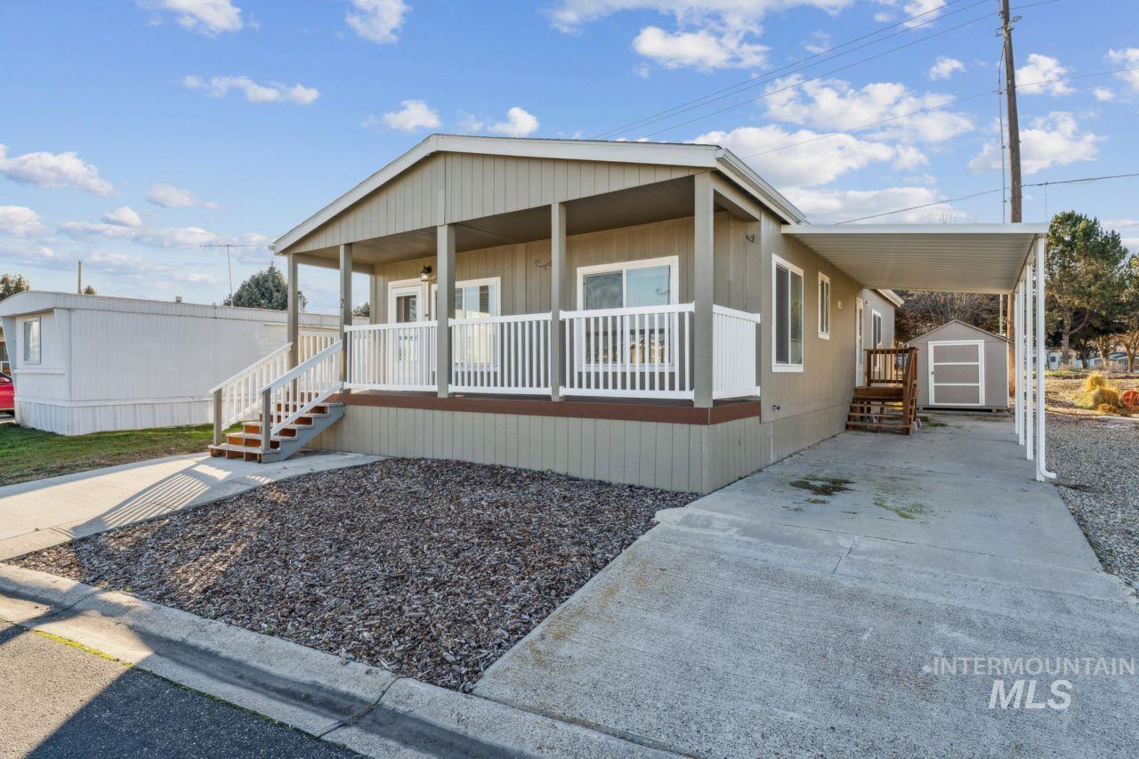 2750 Alden Road, Unit 2 Fruitland, ID 83619 - Photo 21 of 24 Manufactured / mobile home with covered porch, an attached carport, a shed, and concrete driveway
