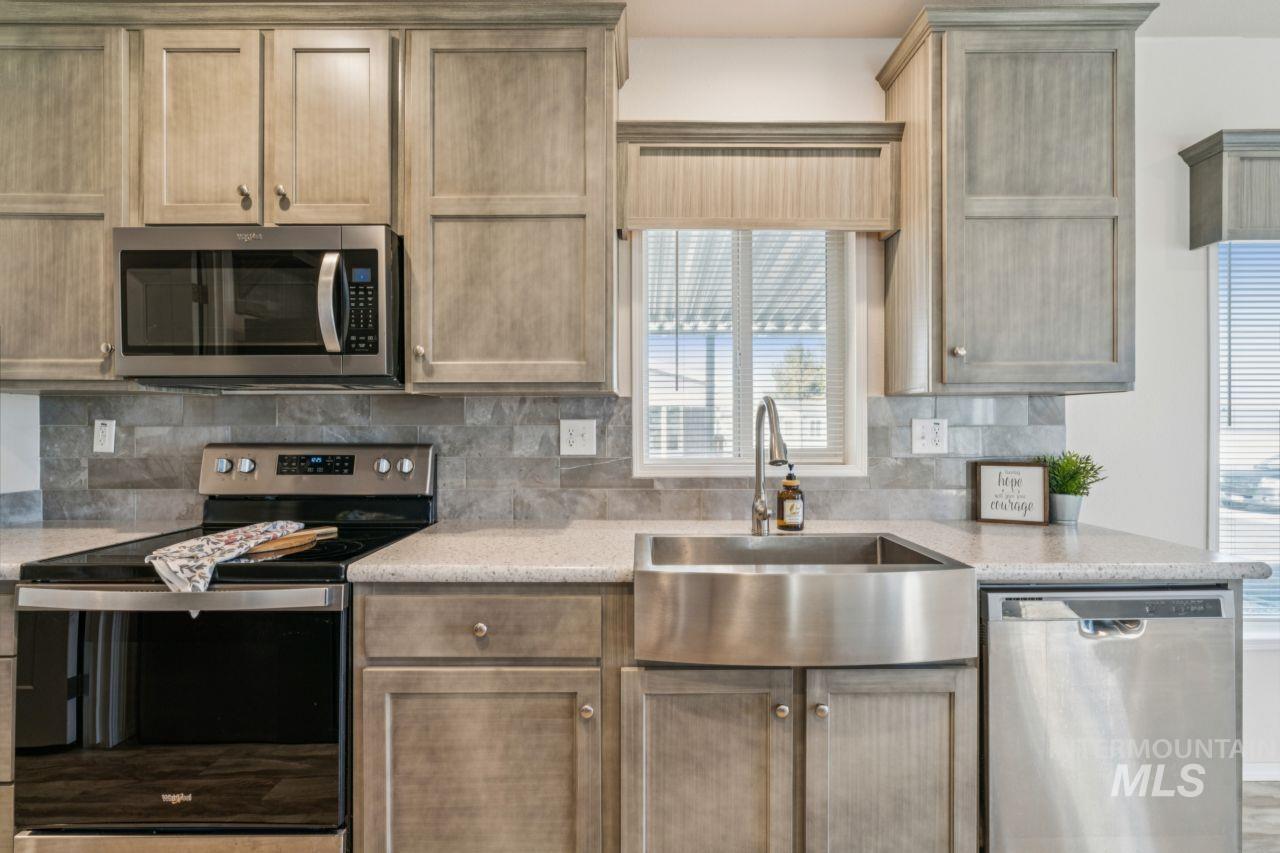 2750 Alden Road, Unit 2 Fruitland, ID 83619 - Photo 5 of 24 Kitchen featuring stainless steel appliances, tasteful backsplash, and light stone counters