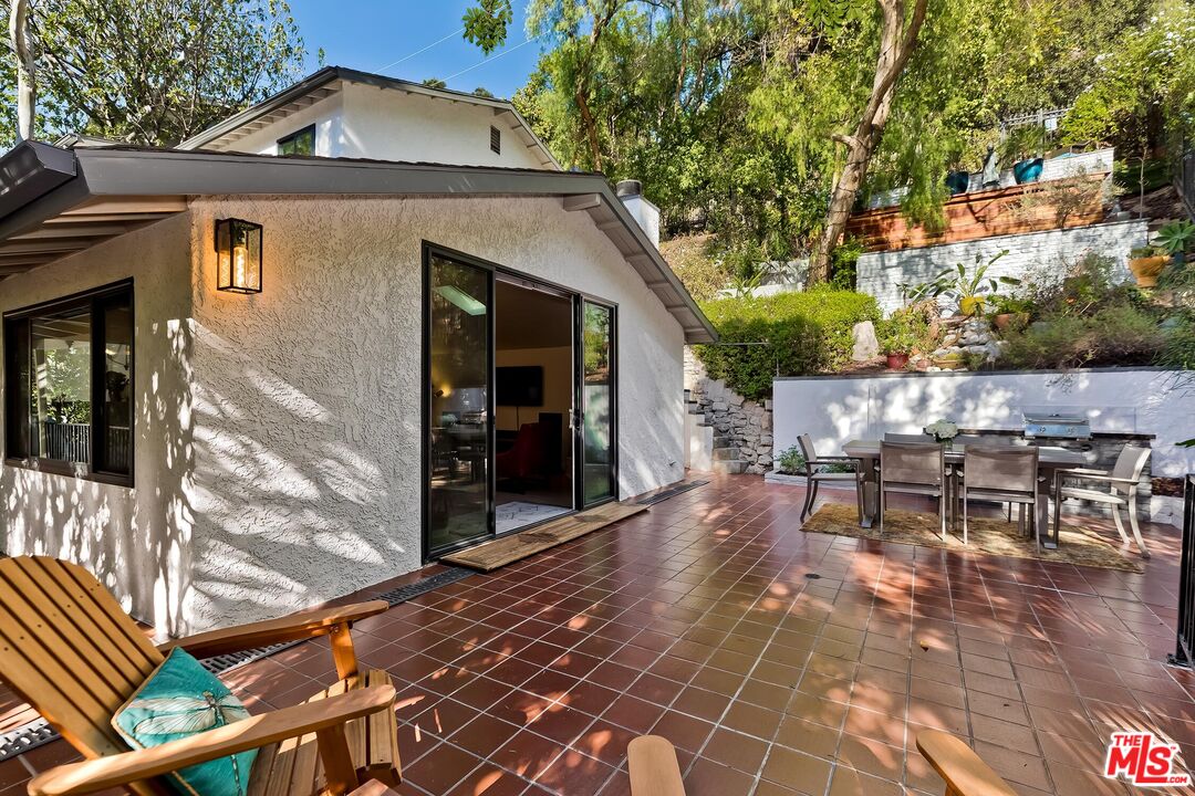 4221 Vanetta Drive Studio City, CA 91604 - Photo 12 of 41 a view of a patio with table and chairs and potted plants