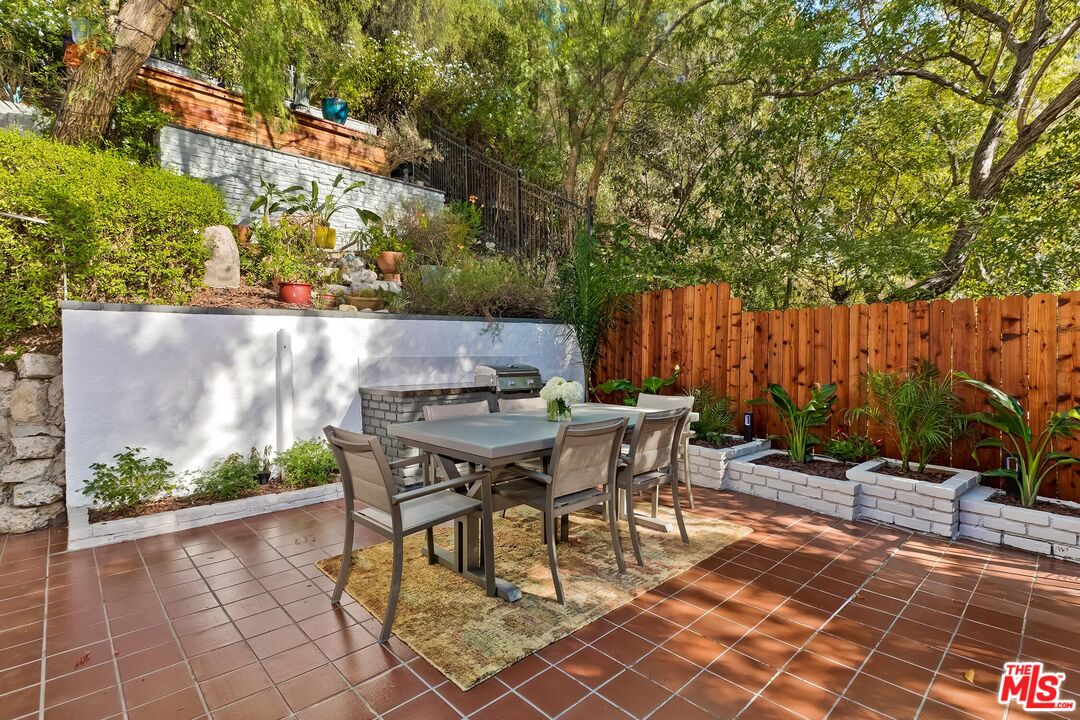 4221 Vanetta Drive Studio City, CA 91604 - Photo 15 of 41 a backyard of a house with table and chairs