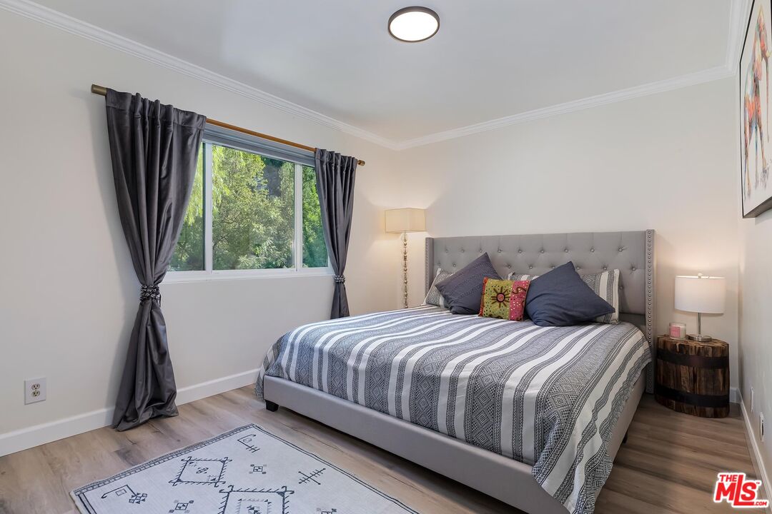 4221 Vanetta Drive Studio City, CA 91604 - Photo 24 of 41 a bedroom with a bed and a window