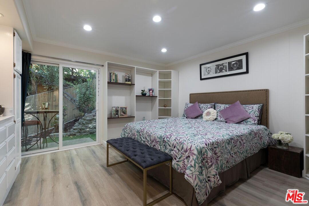 4221 Vanetta Drive Studio City, CA 91604 - Photo 26 of 41 a bedroom with a large bed and a large window