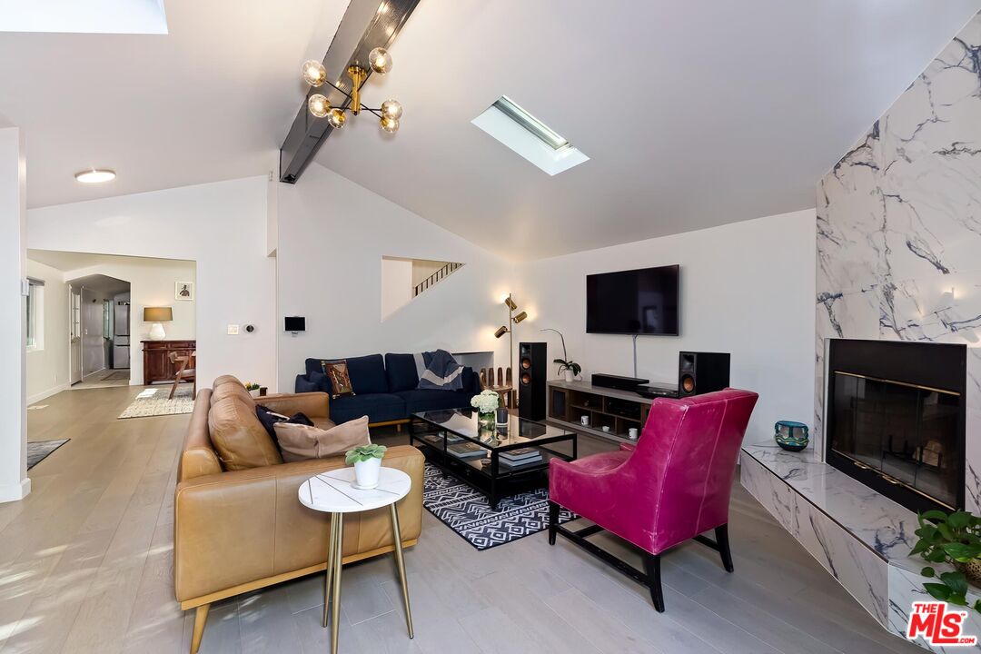 4221 Vanetta Drive Studio City, CA 91604 - Photo 4 of 41 a living room with furniture a flat screen tv and a fireplace