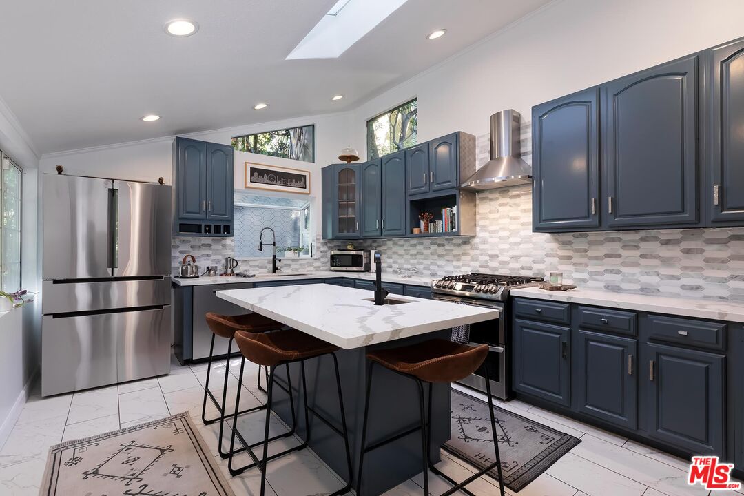 4221 Vanetta Drive Studio City, CA 91604 - Photo 8 of 41 a kitchen with stainless steel appliances granite countertop a sink stove and refrigerator