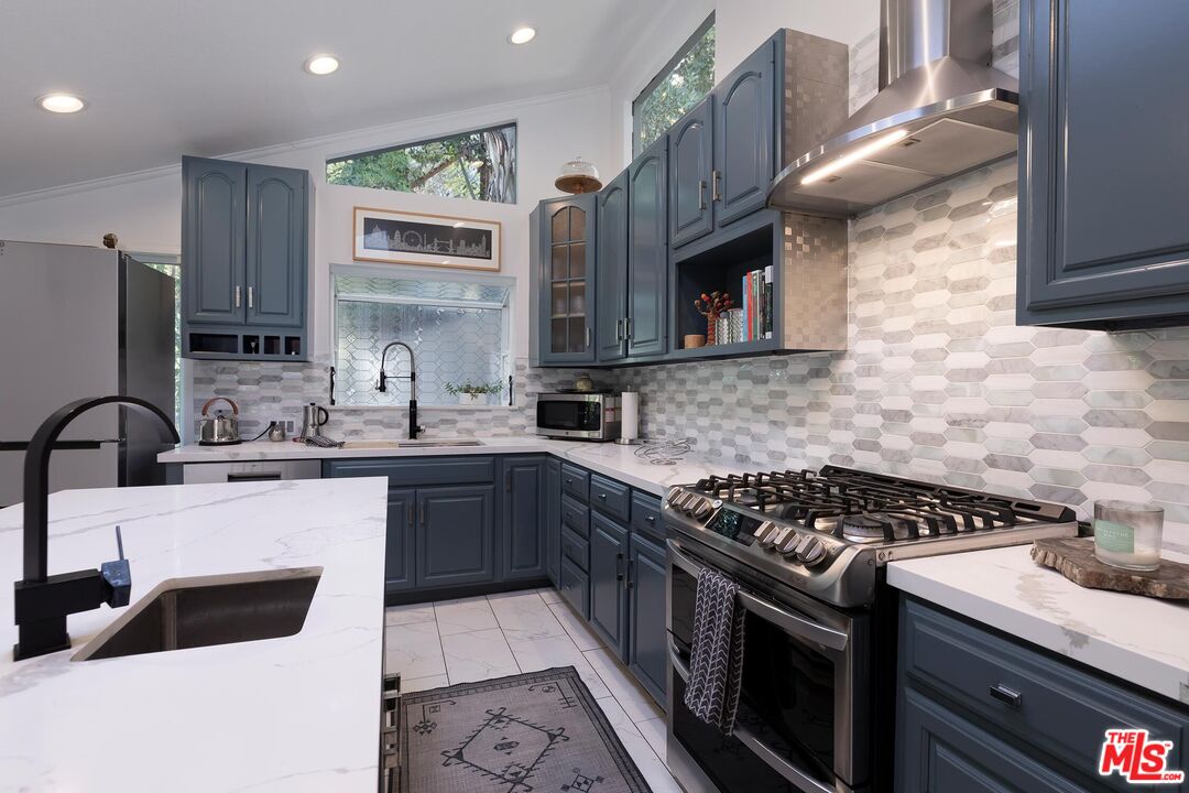 4221 Vanetta Drive Studio City, CA 91604 - Photo 9 of 41 a kitchen with stainless steel appliances a sink stove and cabinets