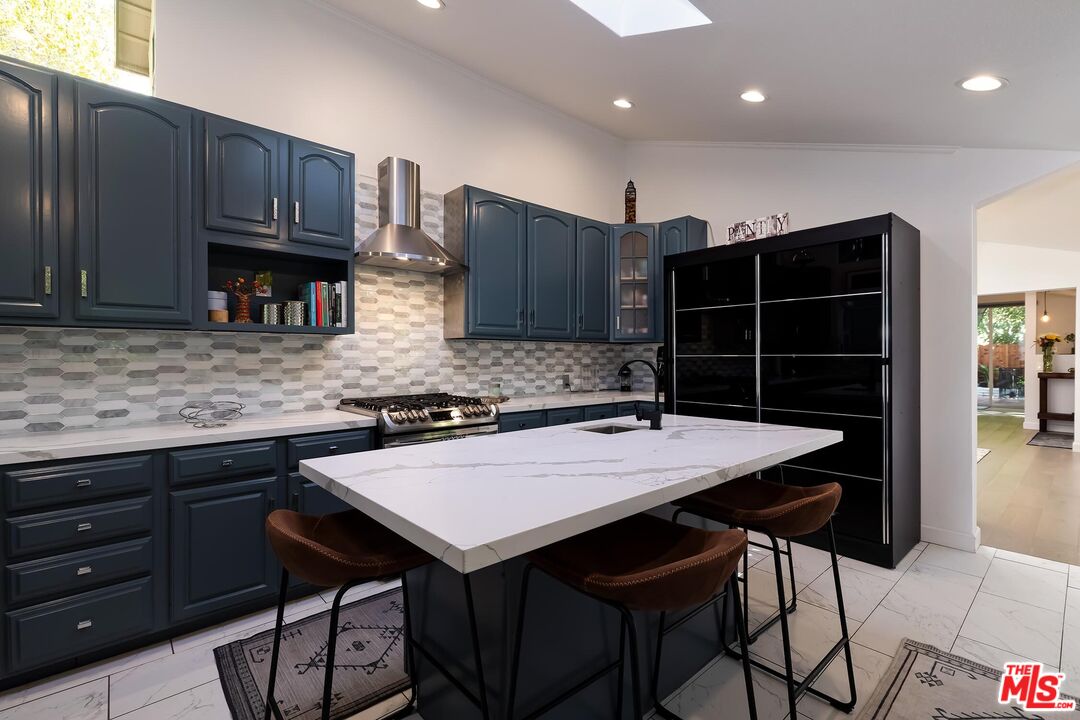 4221 Vanetta Drive Studio City, CA 91604 - Photo 10 of 41 a kitchen with a table chairs and cabinets