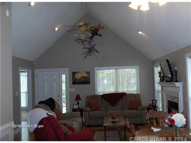 1607 Stack Road Monroe, NC 28112 - Photo 2 of 8 a living room with furniture a fireplace and a chandelier
