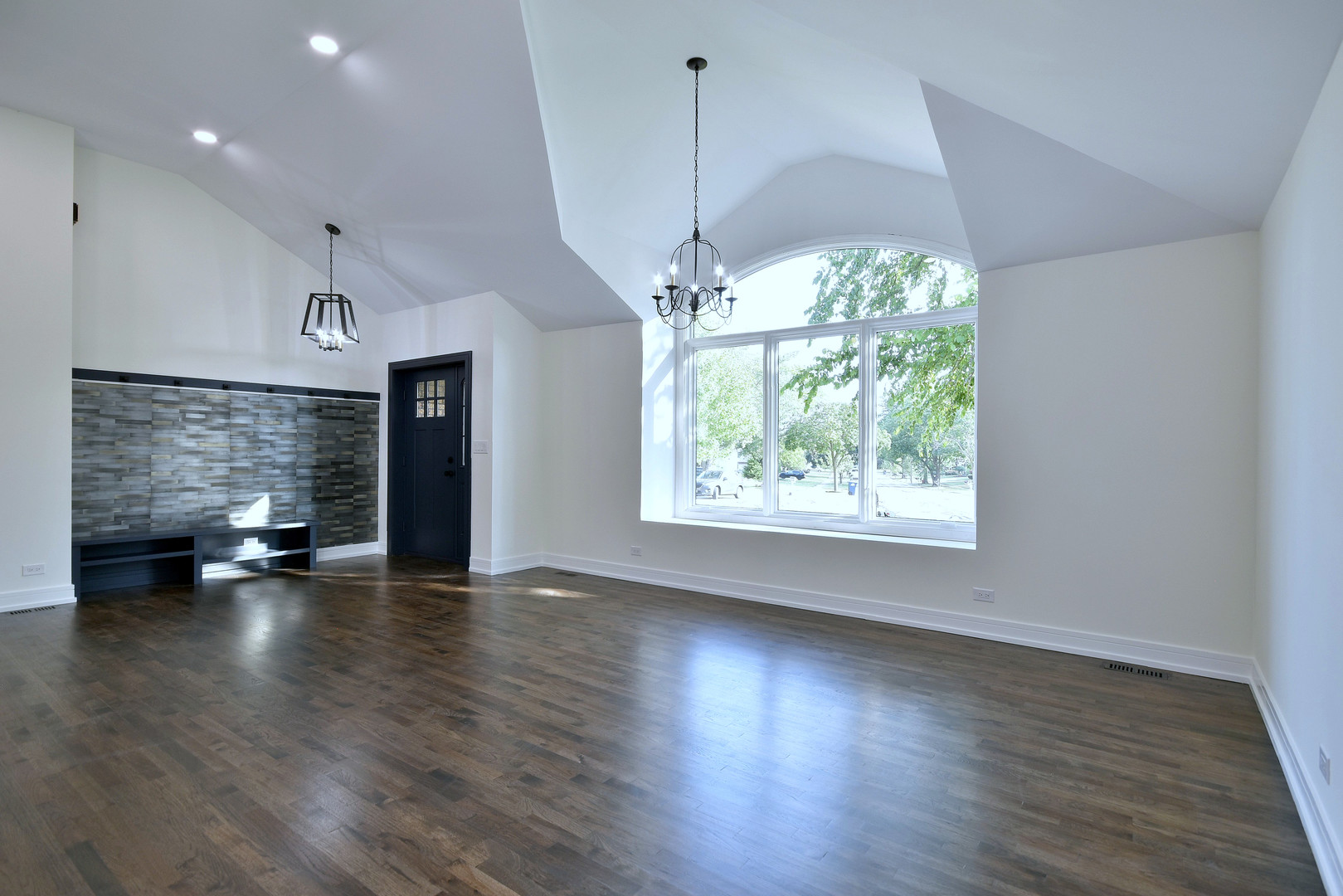 7609 Baker Court Darien, IL 60561 - Photo 11 of 39 an empty room with wooden floor chandelier windows and outdoor view