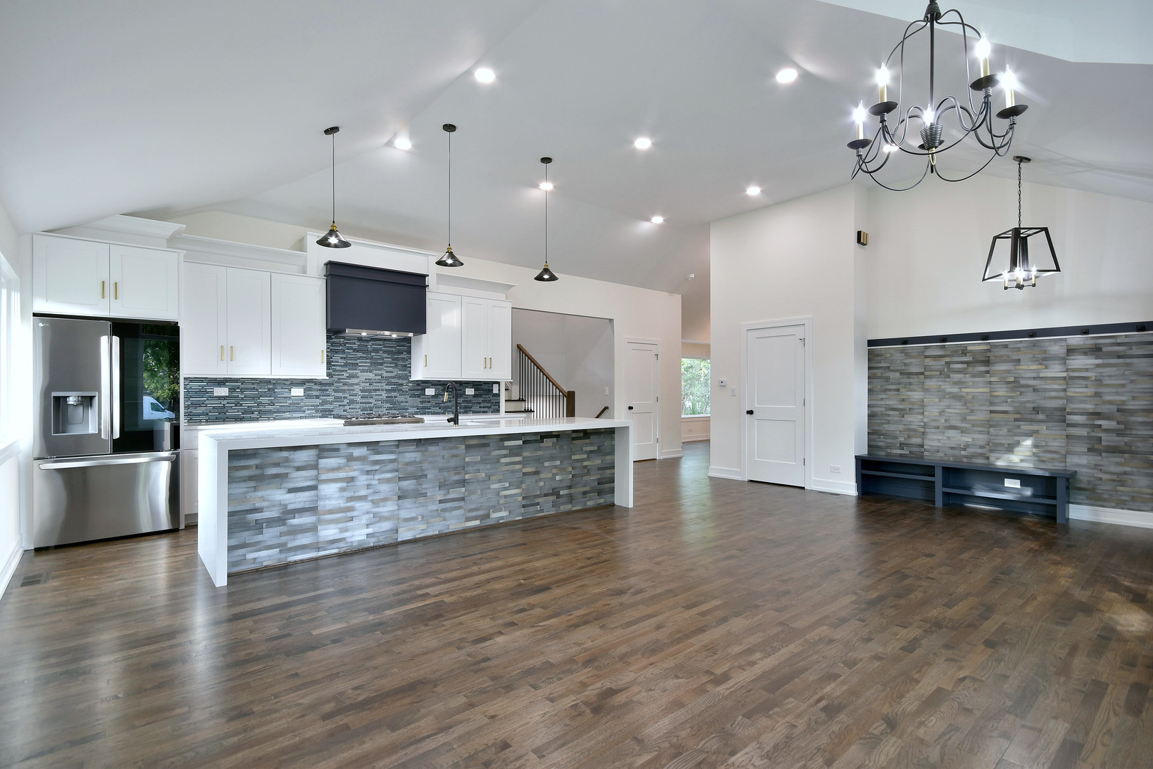 7609 Baker Court Darien, IL 60561 - Photo 13 of 39 a large kitchen with stainless steel appliances a large counter top a stove and a chandelier