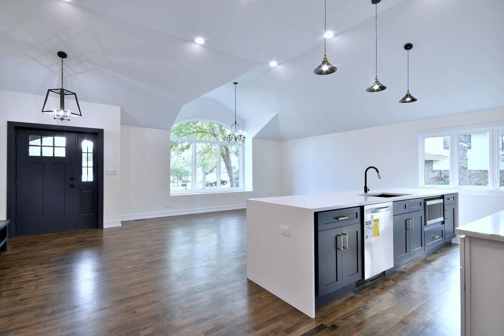 7609 Baker Court Darien, IL 60561 - Photo 17 of 39 a large kitchen with stainless steel appliances granite countertop a stove a sink a center island with wooden floor