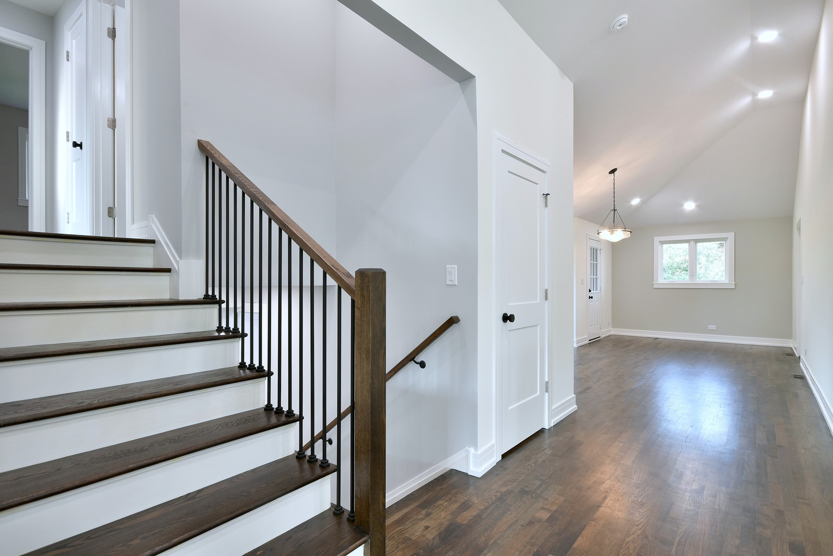 7609 Baker Court Darien, IL 60561 - Photo 19 of 39 a view of a hallway with wooden floor and staircase