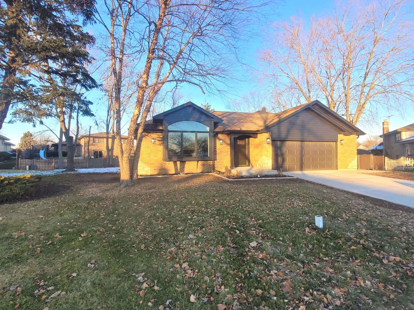 7609 Baker Court Darien, IL 60561 - Photo 2 of 39 a house with trees in front of it