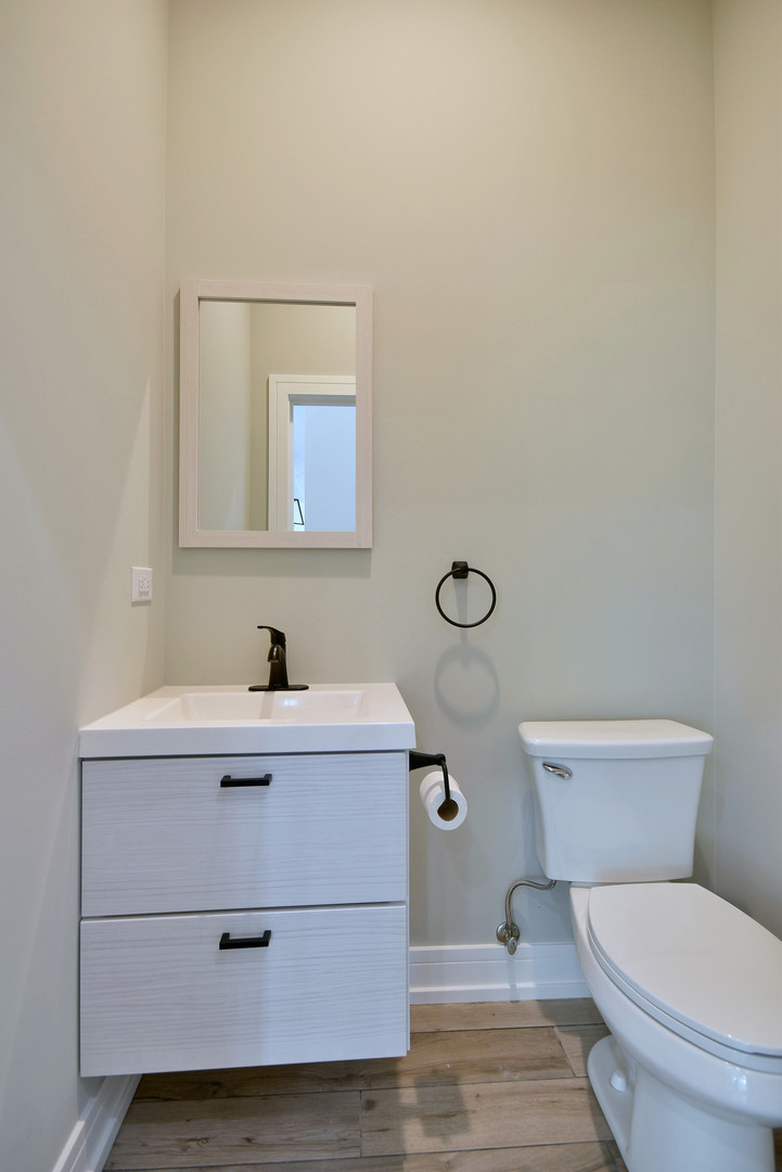 7609 Baker Court Darien, IL 60561 - Photo 21 of 39 a bathroom with a toilet a sink and mirror
