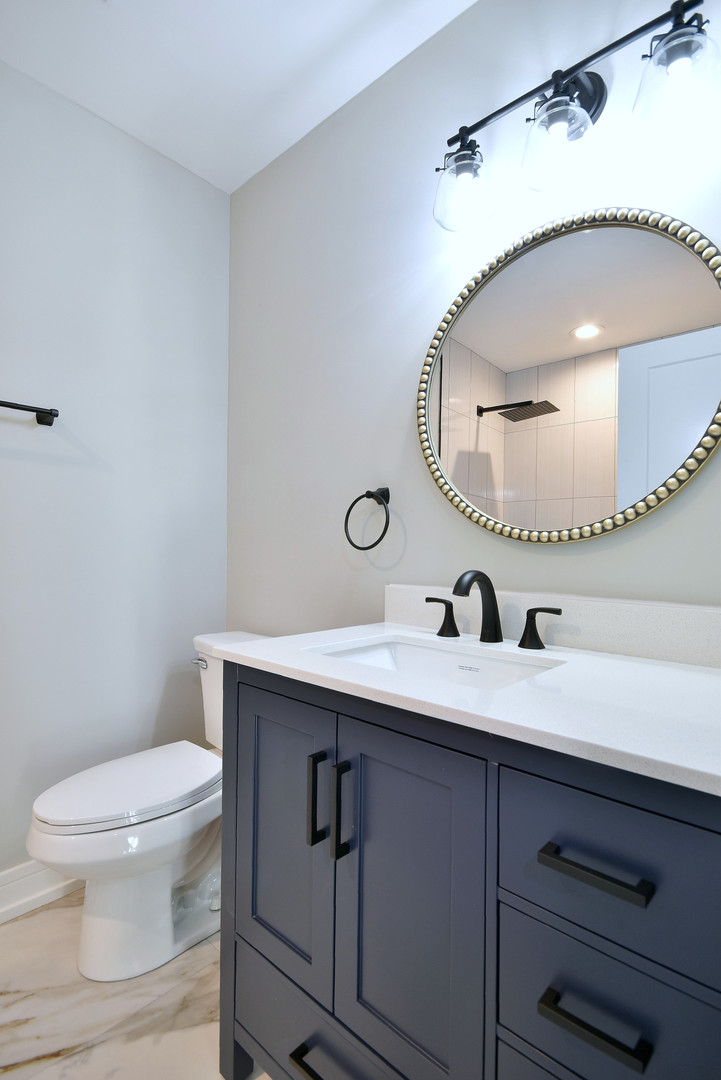7609 Baker Court Darien, IL 60561 - Photo 23 of 39 a bathroom with a sink mirror vanity and toilet