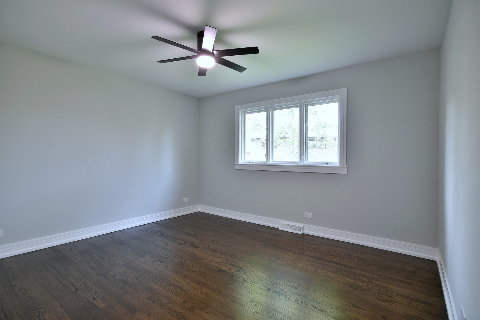 7609 Baker Court Darien, IL 60561 - Photo 26 of 39 an empty room with wooden floor fan and windows