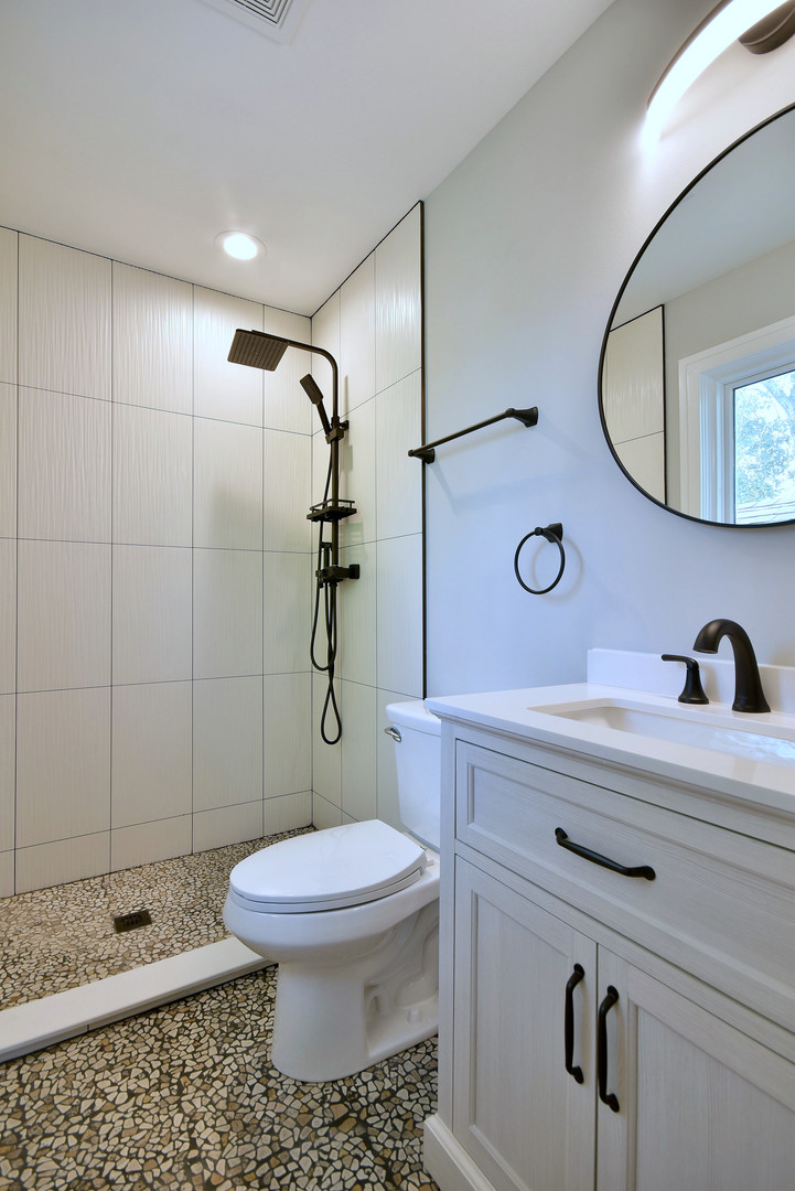 7609 Baker Court Darien, IL 60561 - Photo 29 of 39 a bathroom with a sink a toilet and a mirror