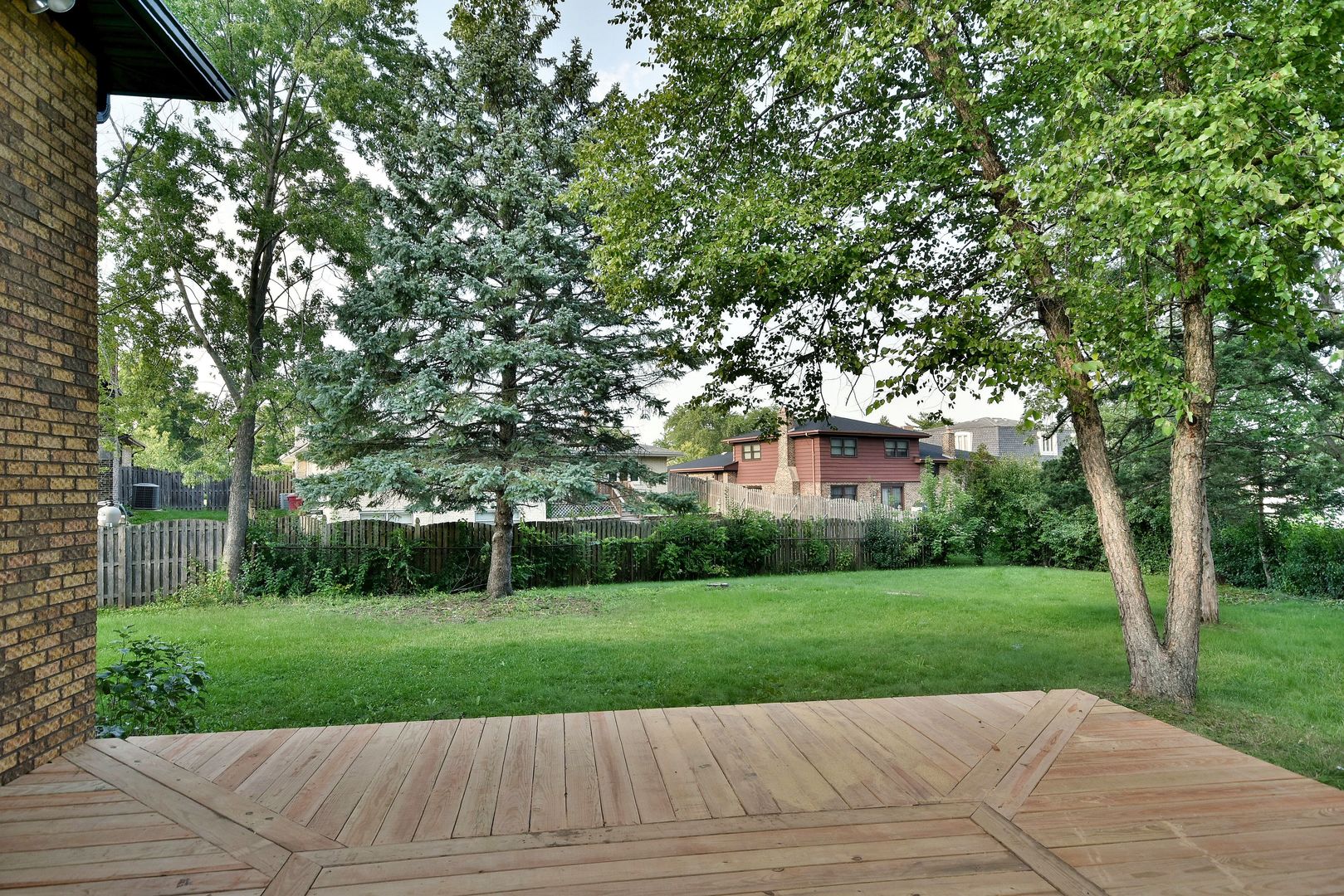 7609 Baker Court Darien, IL 60561 - Photo 6 of 39 a view of a yard with plants and large trees