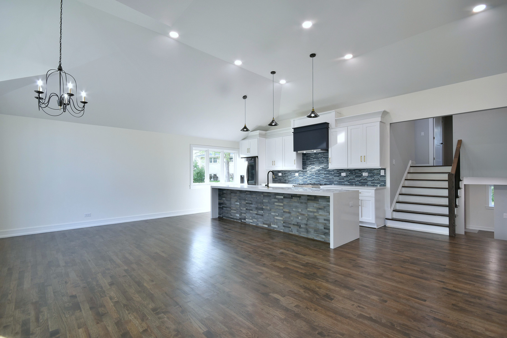 7609 Baker Court Darien, IL 60561 - Photo 8 of 39 an open kitchen with white cabinets and stainless steel appliances