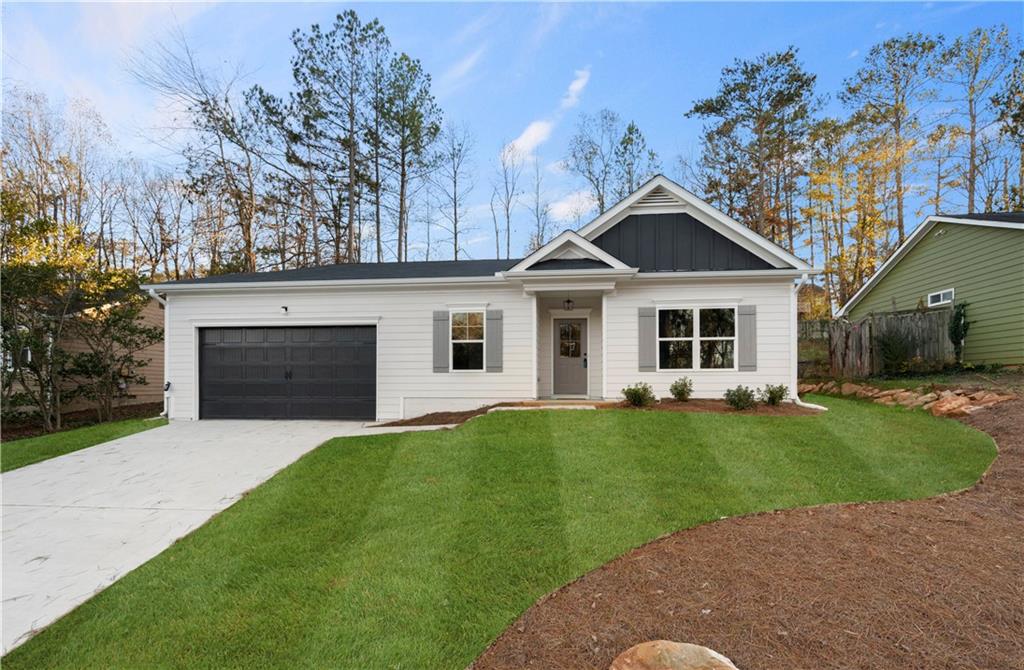 a front view of a house with a garden and yard