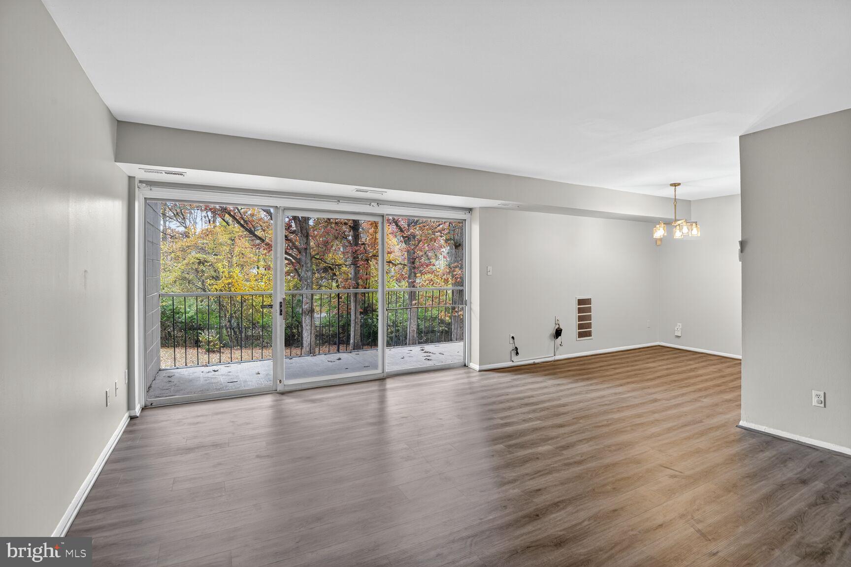 7505 Riverdale Road, Unit 2039 Hyattsville, MD 20784 - Photo 2 of 15 wooden floor in an empty room with a window