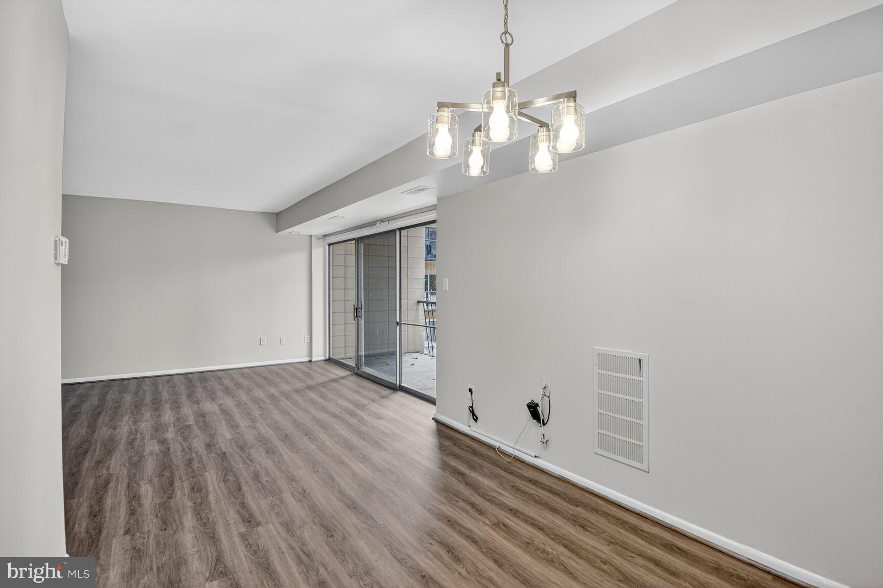 7505 Riverdale Road, Unit 2039 Hyattsville, MD 20784 - Photo 7 of 15 wooden floor in an empty room with a window