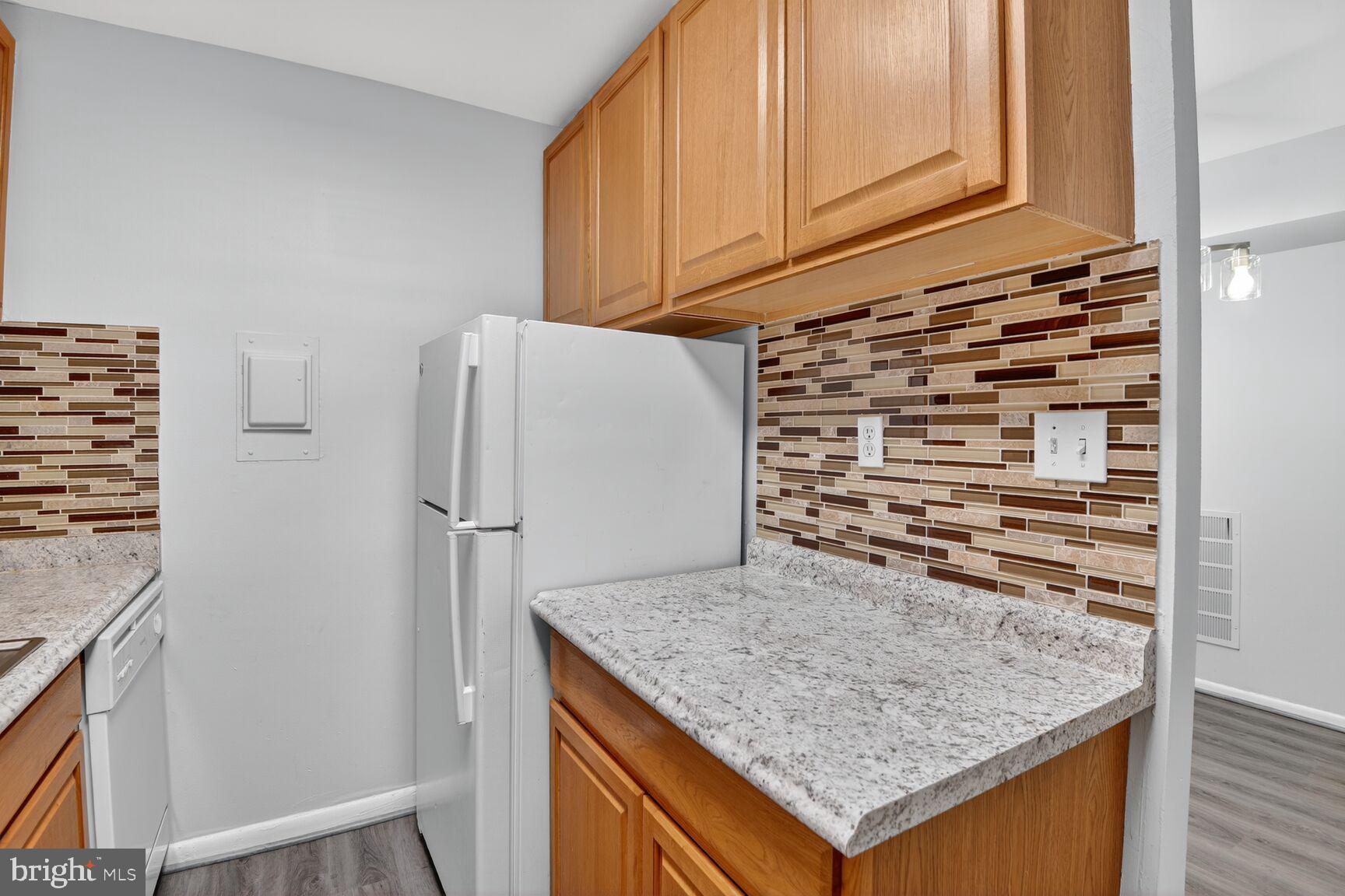 7505 Riverdale Road, Unit 2039 Hyattsville, MD 20784 - Photo 10 of 15 a kitchen with a refrigerator and countertop