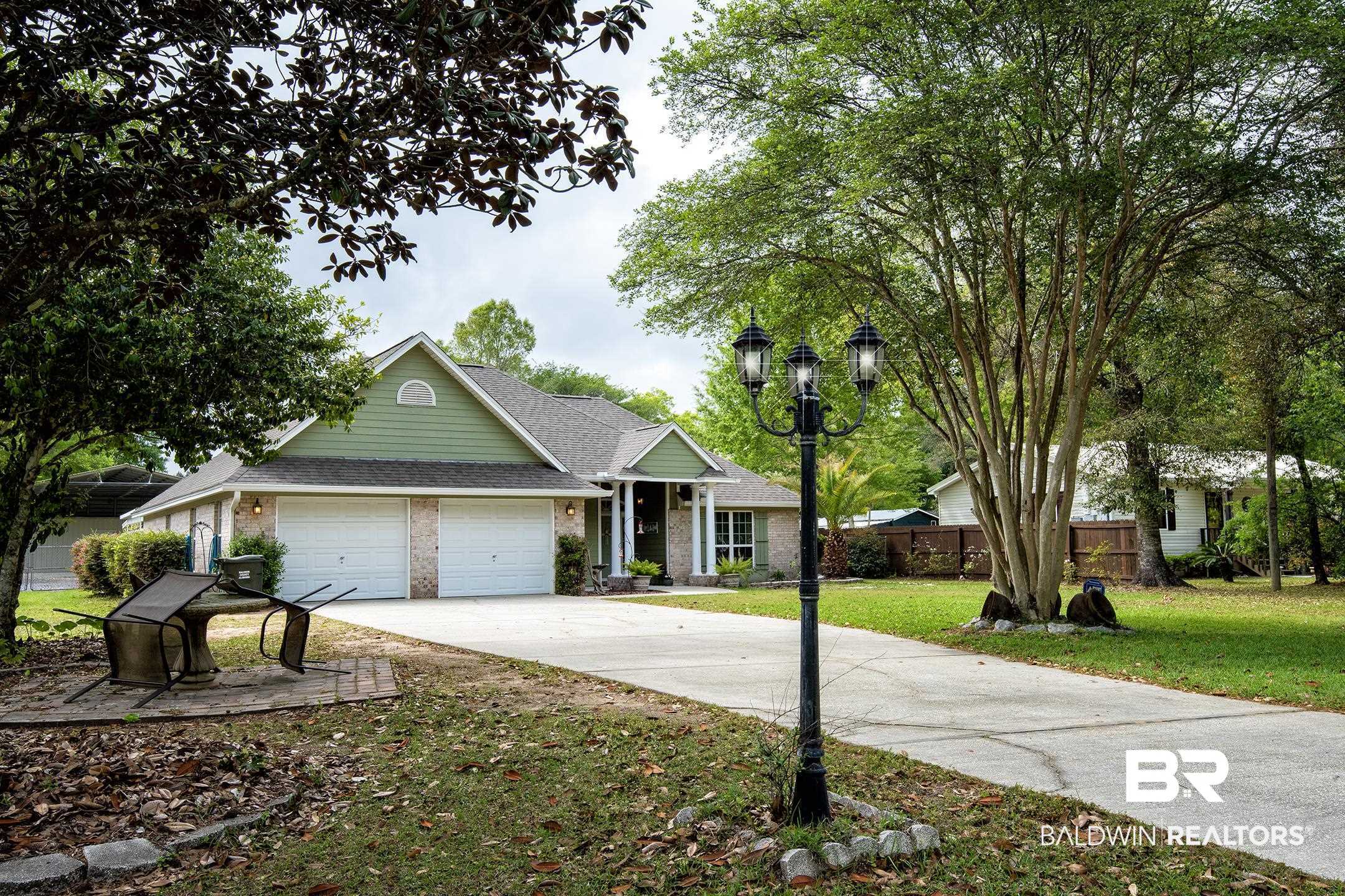 10093 Willis Road Foley, AL 36535 - Photo 2 of 33 View of front of home featuring brick siding, a shingled roof, an attached garage, and driveway