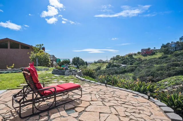 a chair and table with umbrella in the background