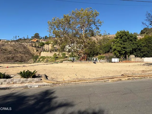 a view of yard covered with snow in front of house