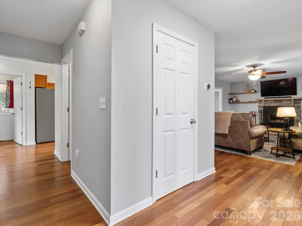 a view of a livingroom with wooden floor and furniture