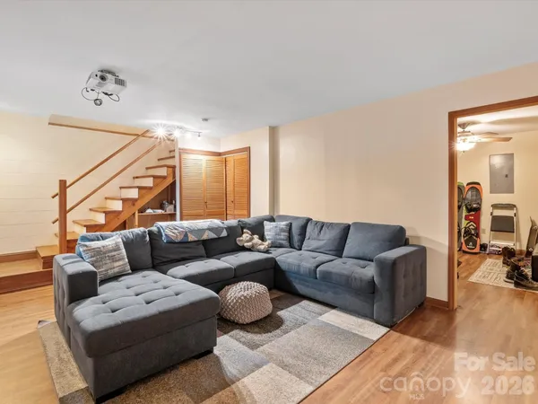a living room with furniture and a wooden floor