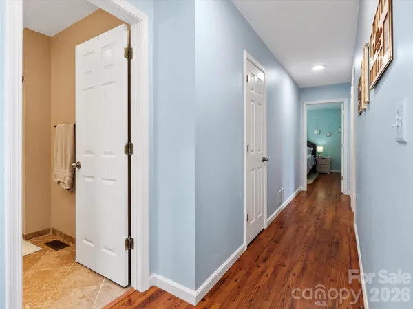 a view of hallway with wooden floor