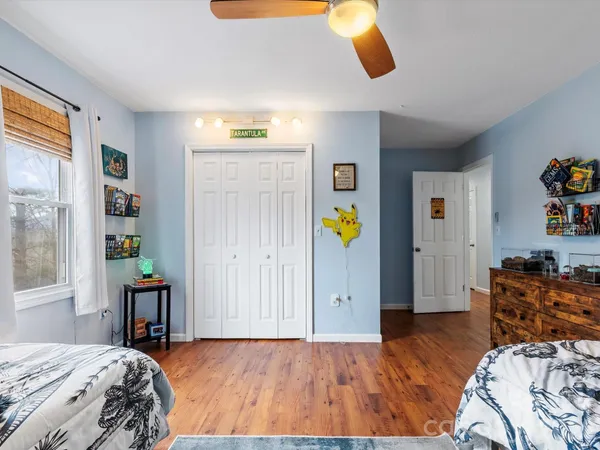 a bedroom with a bed and dresser